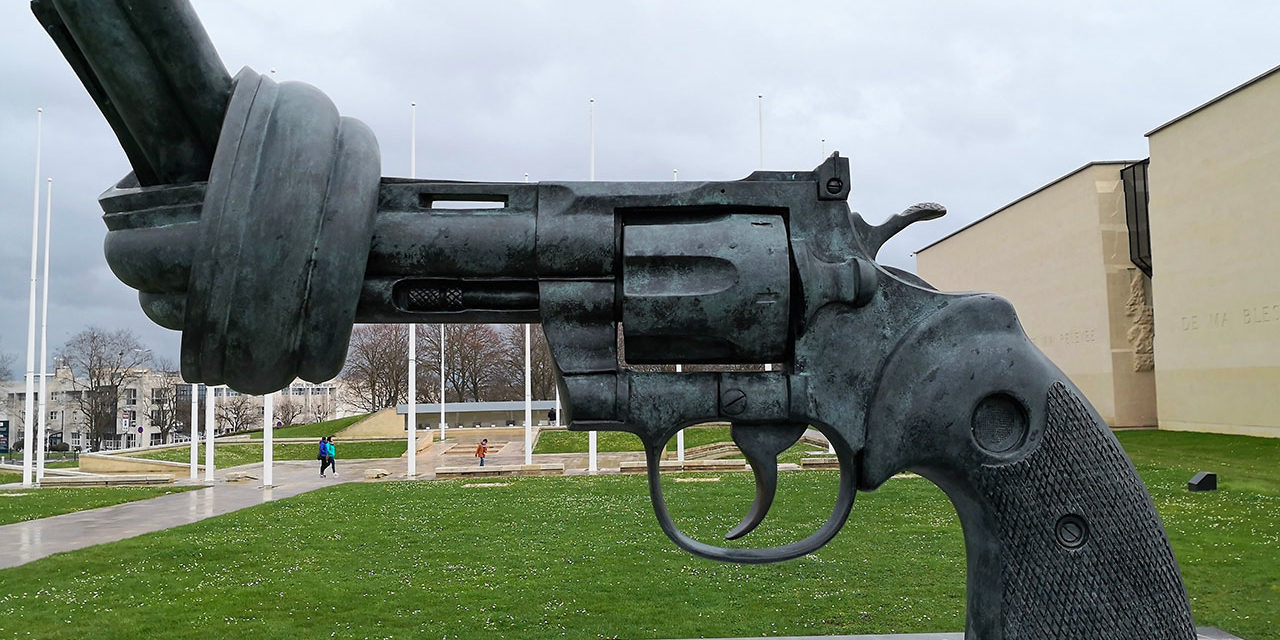 https://www.adrian-roads.com/wp-content/uploads/2019/03/Memorial-de-Caen-Gun-statue-no-more-weapons-1280x640.jpg